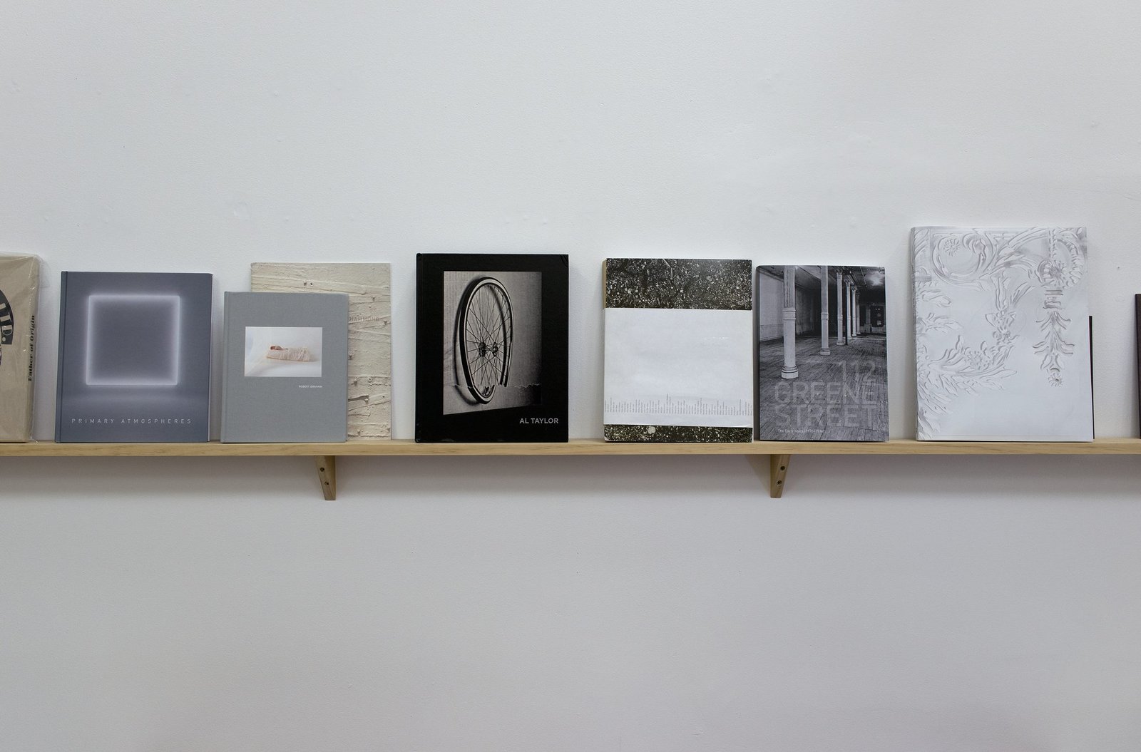 A long shelf holding art books and monographs designed and printed by the studio.